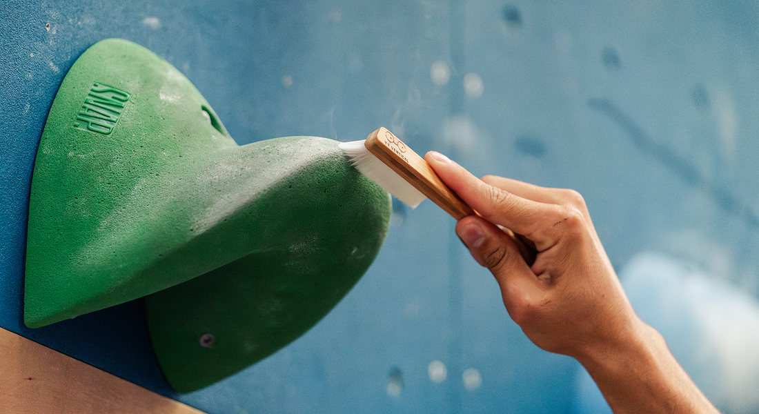 Why is it essential to brush your holds when climbing?